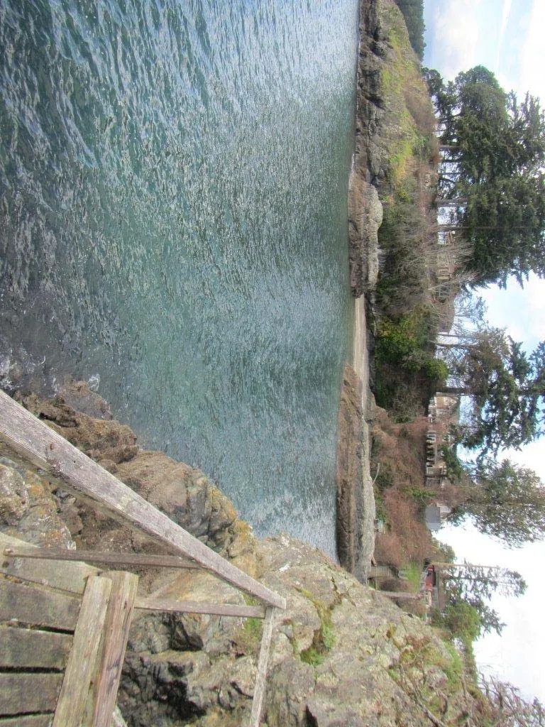 View from the deck along the rocky shoreline towards a neighboring property