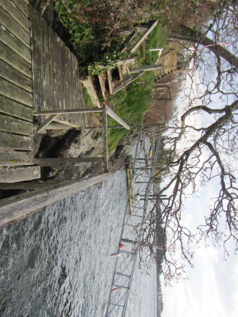View of the steep rock face and the stairs leading down to the private dock