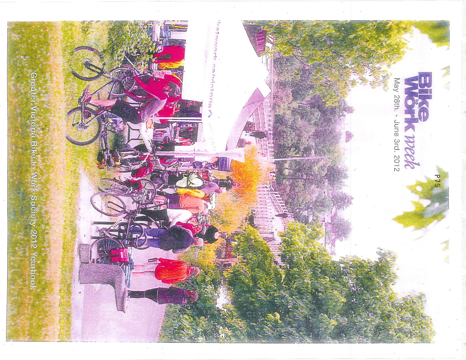 Cover of the yearbook featuring participants and cyclists gathered at an event station under a white tent near a bridge.