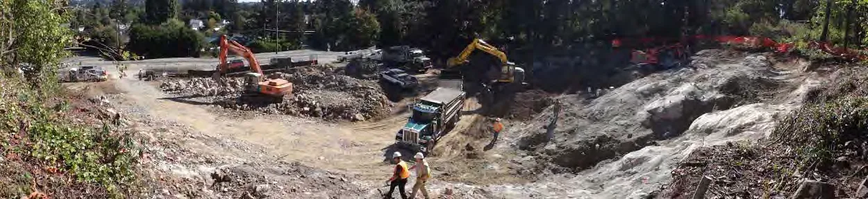 Construction site excavation progress showing exposed rock and heavy equipment, 11 September 2013