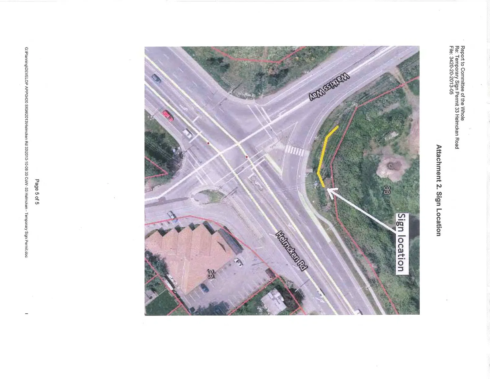 Aerial photograph of the intersection of Watkiss Way and Helmcken Road, with a yellow line and white arrow indicating the proposed sign location on the property at 33 Helmcken Road.