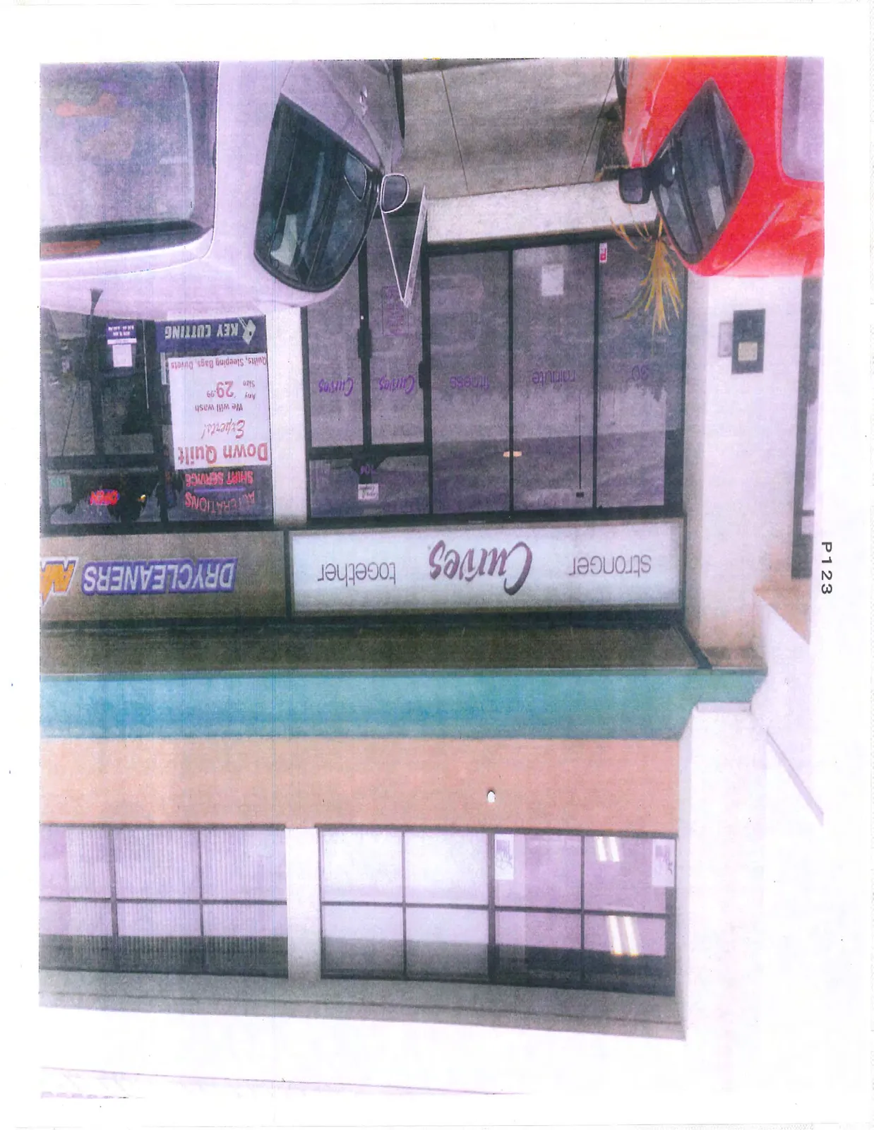 Close-up photograph of the "Curves" and "Drycleaners" storefronts used for the sign rendering.
