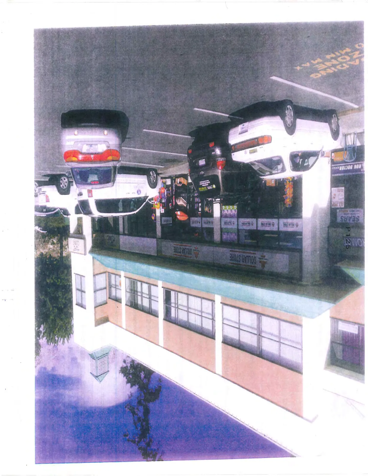 Wide-angle photograph showing the "Dollar Store" storefront and parking area of the commercial building.