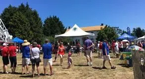 Large crowd gathered on a field for the Canada 150 Celebration