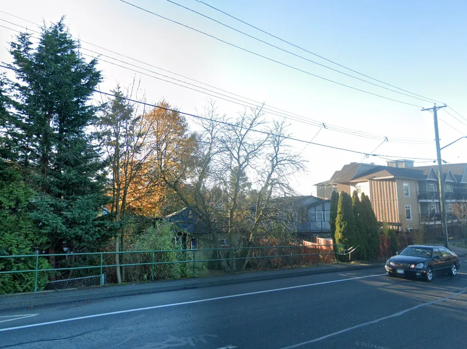 Photo from Helmcken Road looking East at existing house and trees