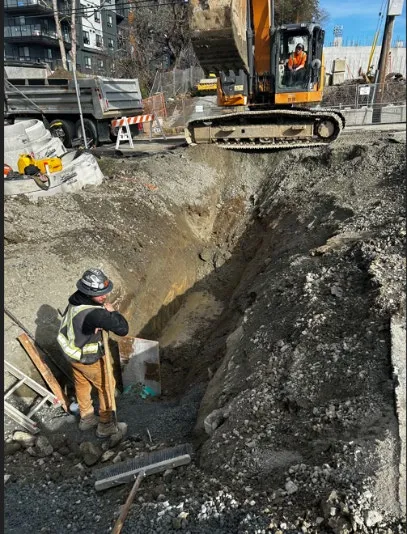 Construction equipment and excavation for drain outfall pipe at 7 Erskine Lane