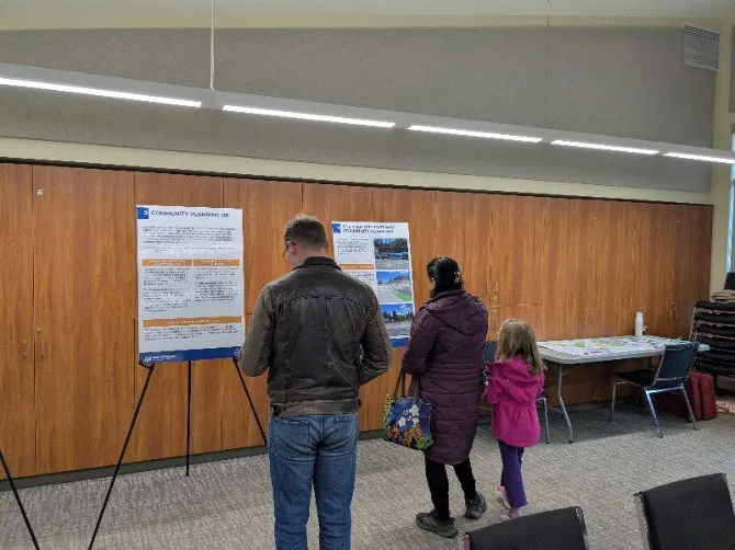 Two people looking at OCP display boards