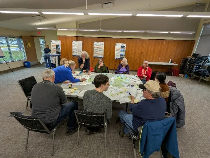 Group of participants sitting at a round table for an OCP workshop