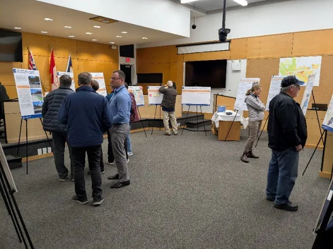 Group of people viewing posters in a meeting room during the OCP engagement