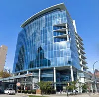 photo of a tall, glass-clad building with a curved design