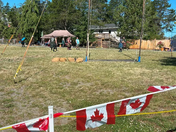 Some of the heavy events - Highland Games competitors on a field