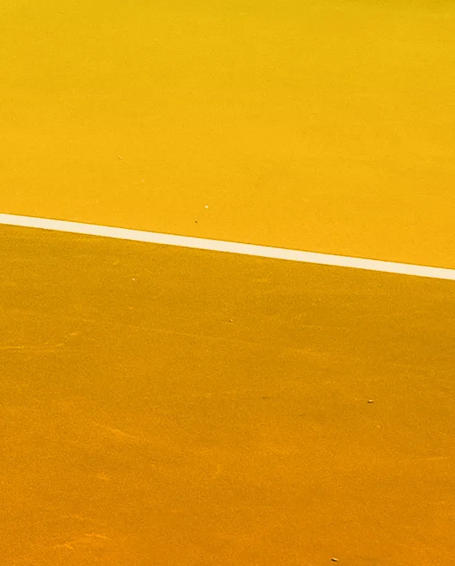 Close-up of players' feet and the bottom of a sports net on a court
