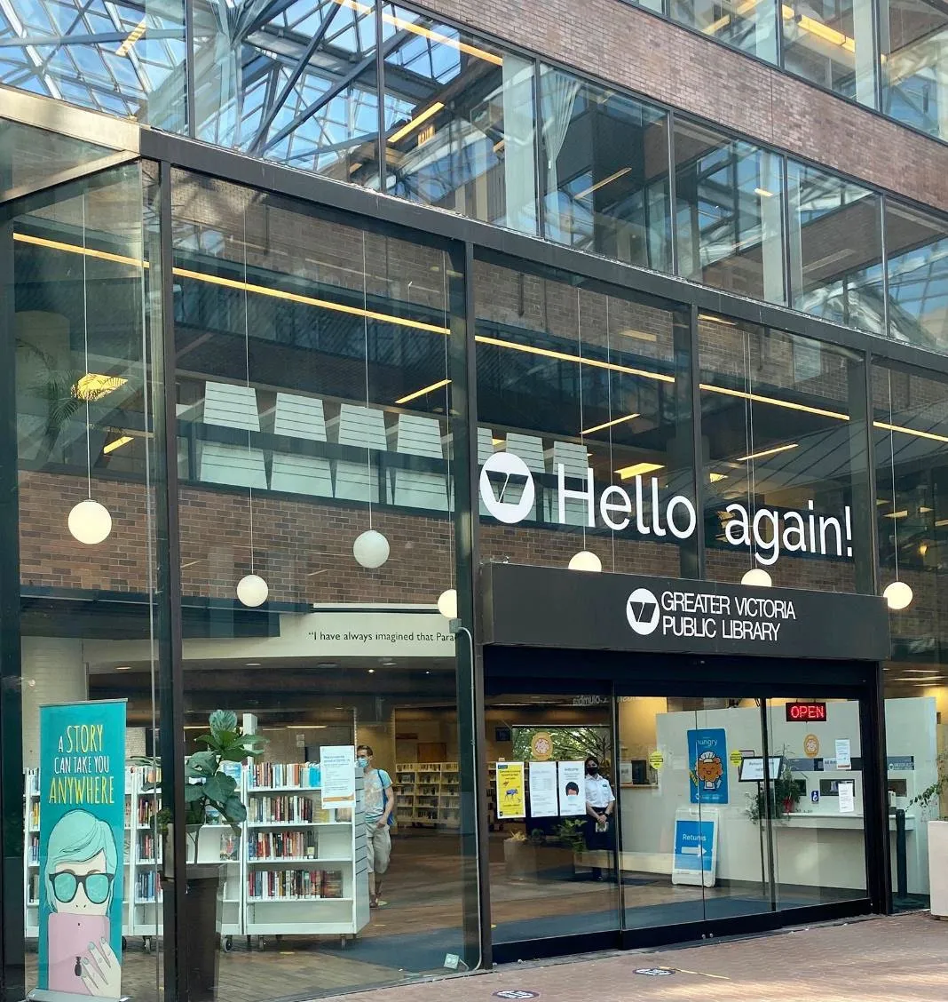 Photo of the Greater Victoria Public Library entrance with "Hello again!" signage.