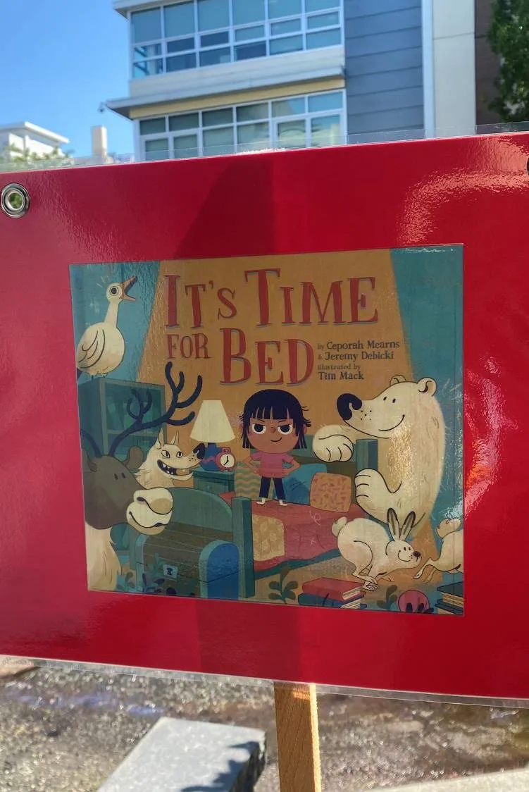 Photo of an outdoor StoryWalk display for the book "It's Time for Bed."