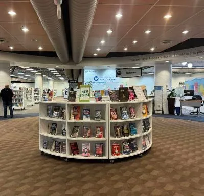 Photo of a circular display unit featuring new book titles.
