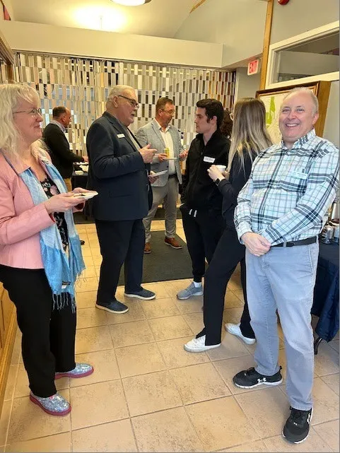 Attendees networking at the business mixer
