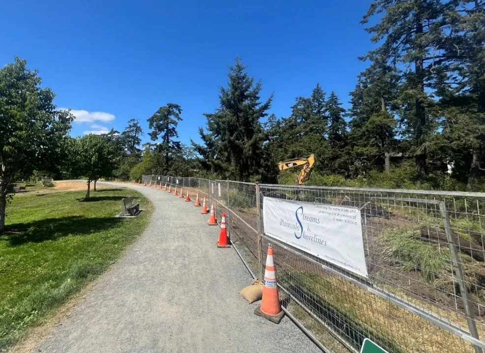 Project area looking North featuring a gravel path and construction fencing