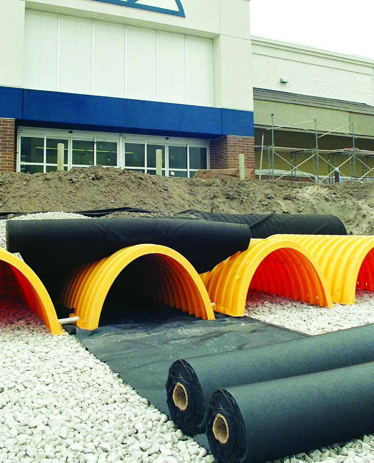 Installation of SC-740 StormTech chambers with rolls of geotextile fabric