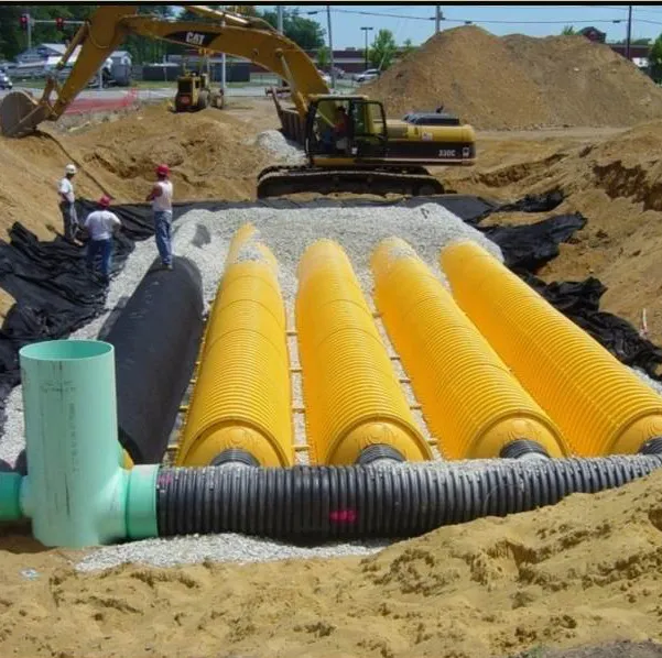 Construction site showing installation of yellow StormTech chambers