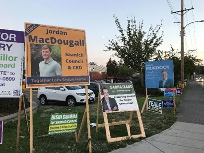 Photograph of election signs for candidates Trevor Barry and Jordan Reichert