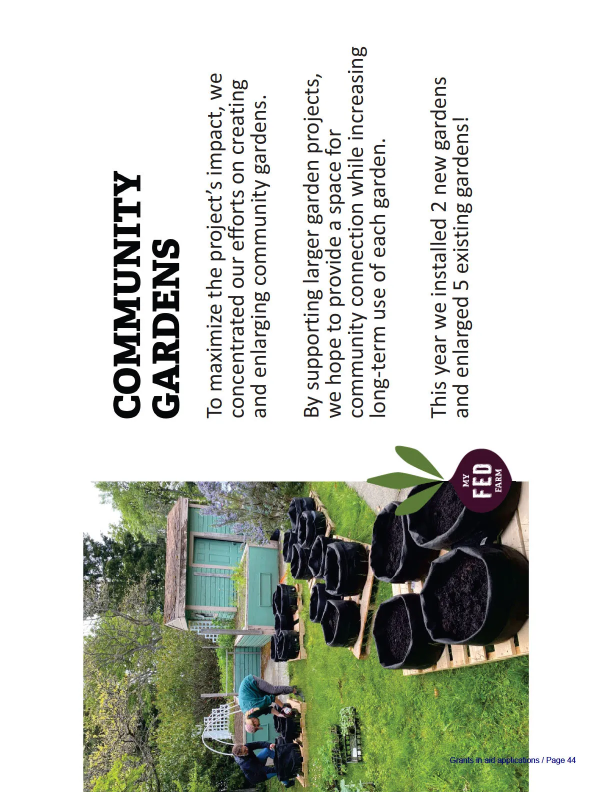 Photograph showing the installation of a community garden with large black grow bags placed on wooden pallets