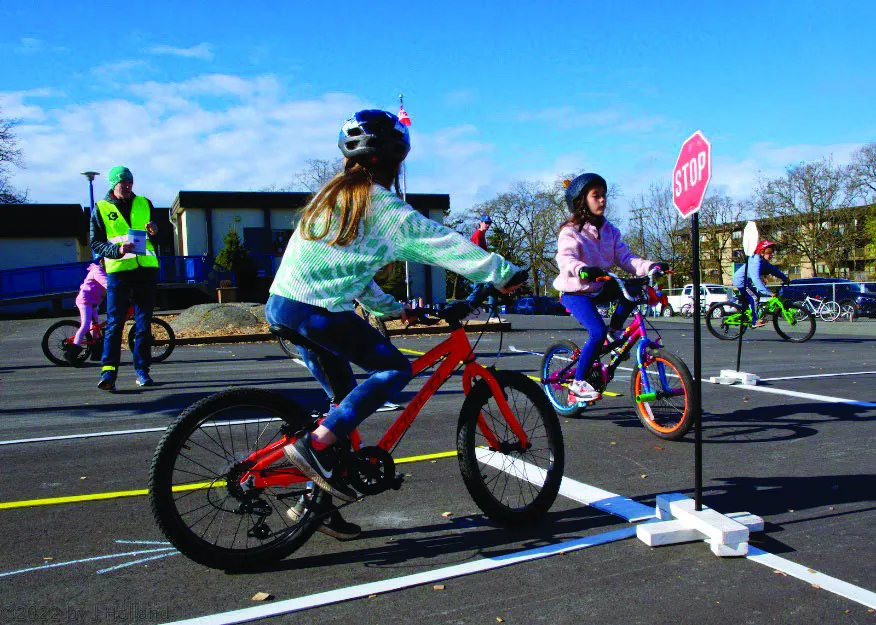 Students learn the concept of “right of way” at a mock 2-way intersection.