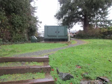 Entry to Tovey Shoreline Access area with bollards and remnant stone planters, looking south-east