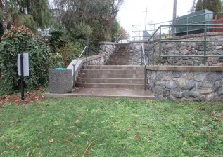 View of the bottom of the stairs and grassy shoreline area