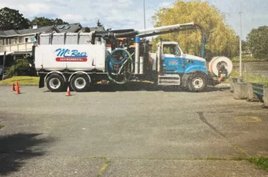 Side view of a McRae Environmental truck parked at the site