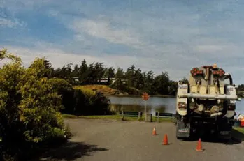 View of the road end area with two work trucks and traffic cones