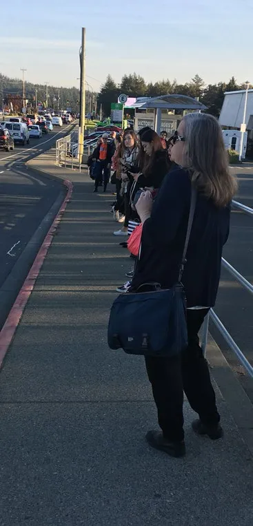 Scale rendering of the bus stop pole signage next to a human silhouette