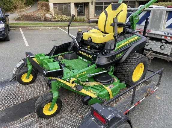 side view of new zero-turn mower on trailer