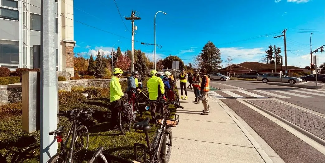 Participants gathered at the Watkiss Way / Helmcken Road intersection discussing the challenges of accessing the Galloping Goose Trail.