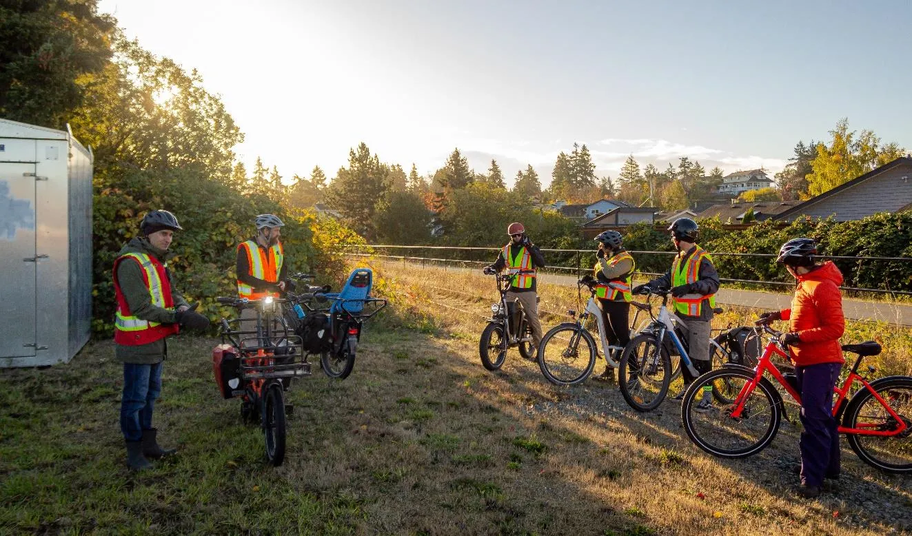 Participants gathered at the E&N Rail Trail & Burnett Road intersection during the bikeshop tour.