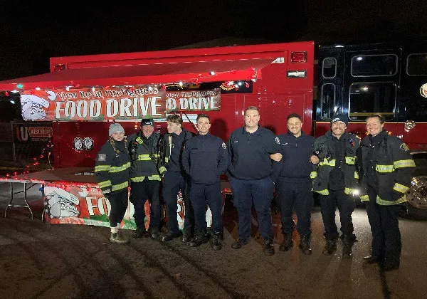 Members standing in front of the Truck Light Convoy and Food Drive truck