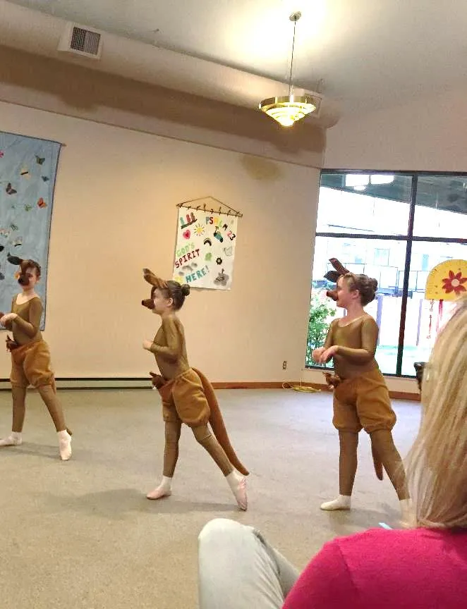 Children in kangaroo costumes performing a dance
