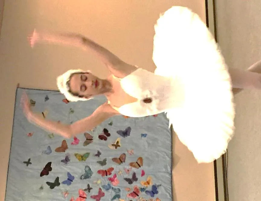 Ballerina in a white tutu performing a dance