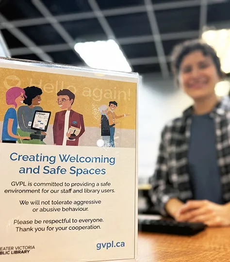 Sign on a library desk titled 'Creating Welcoming and Safe Spaces'