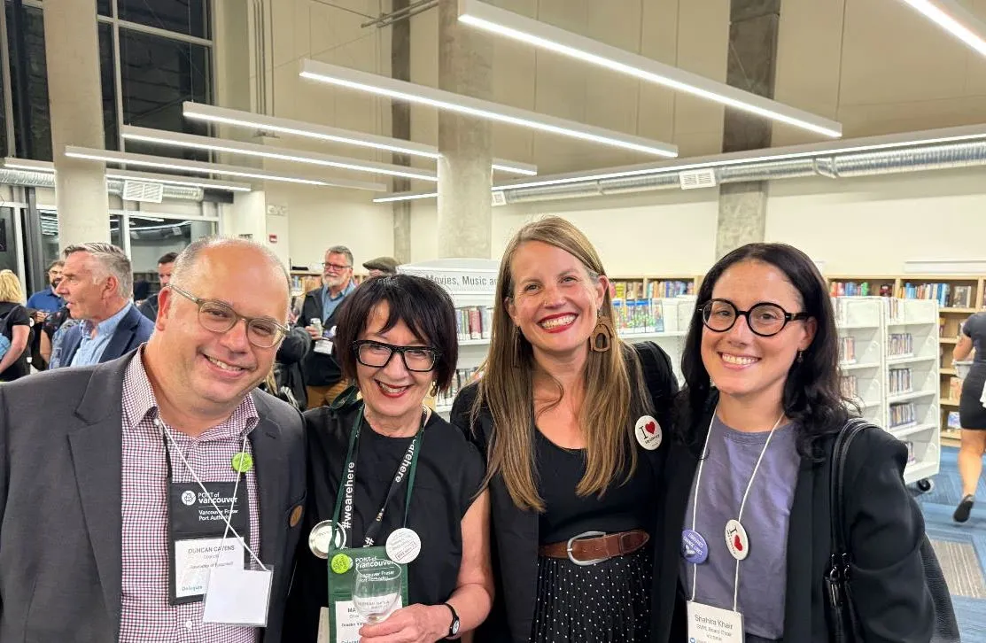 Four people smiling at a library event