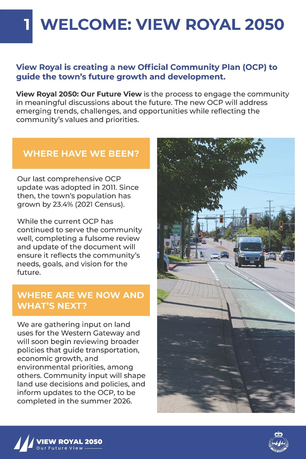 Photograph of the Western Gateway corridor showing a street with a green-painted bike lane, sidewalks, and a transit van