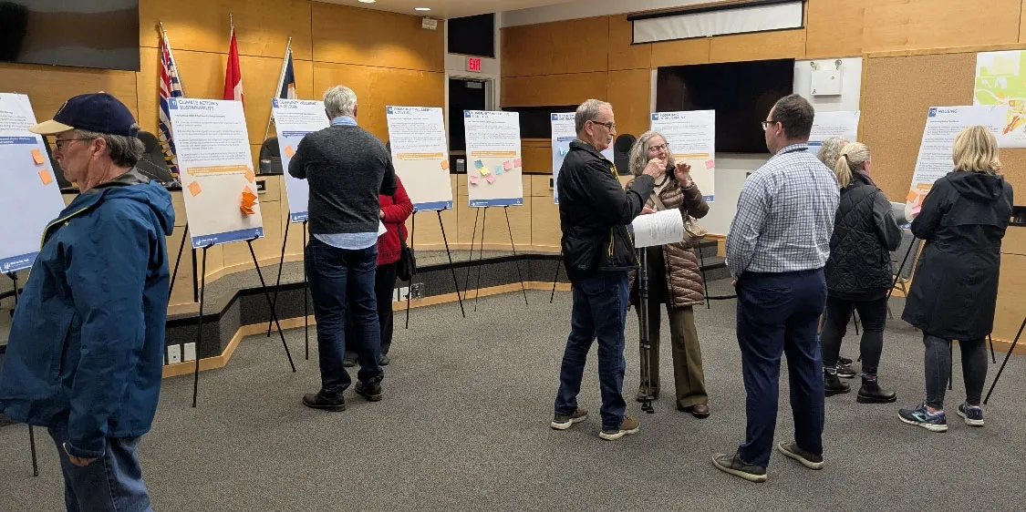 Community members participating in an open house event, viewing display boards