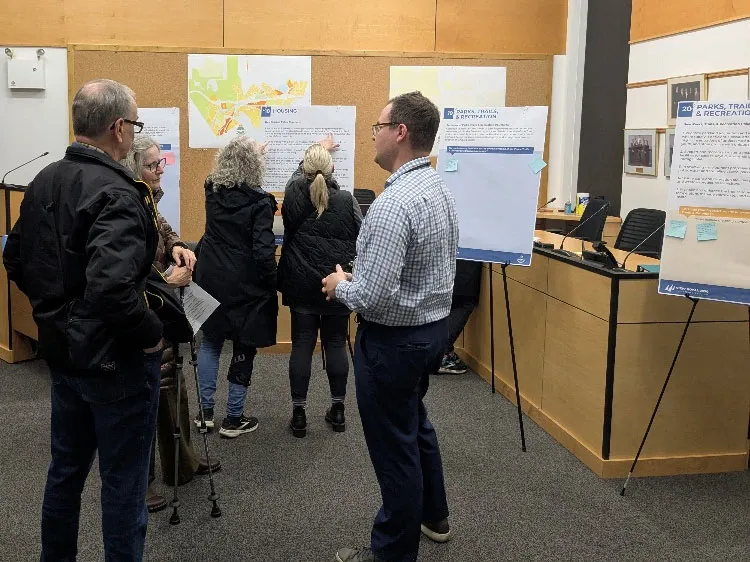 Project team member discussing the OCP update with community members at an open house
