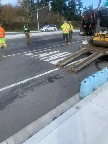 Pavement repairs being conducted by staff on a main road