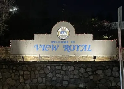 Illuminated Welcome to View Royal sign at night