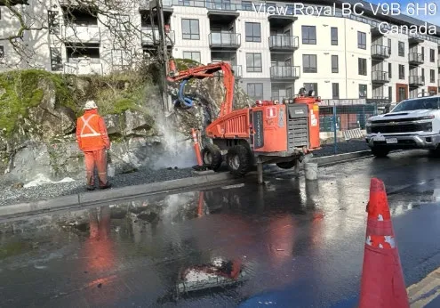 Rock shearing and sidewalk construction work in progress along Helmcken Road