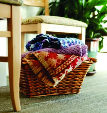 Woven basket containing various blankets