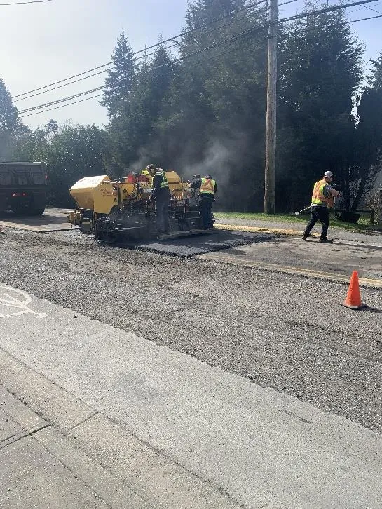 Photo of paving equipment and workers on Island Highway