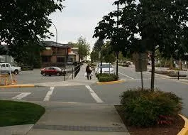 A curb choker at a street entry narrowing the available roadway width.