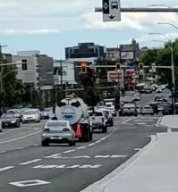 View of a street with transit signals and traffic.