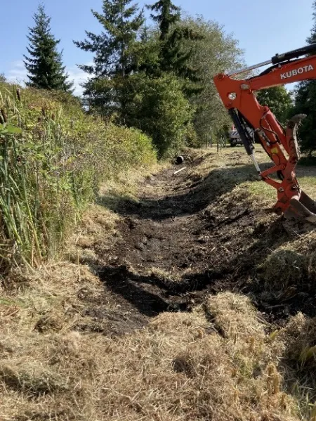 ditch clearing in progress with machinery